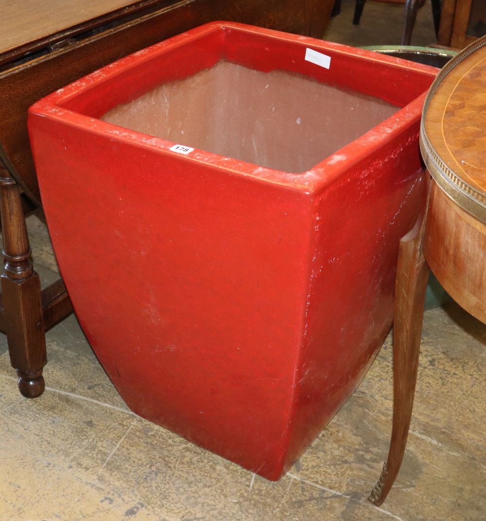 A red clay glazed terracotta square garden planter, W.54cm, H.67cm